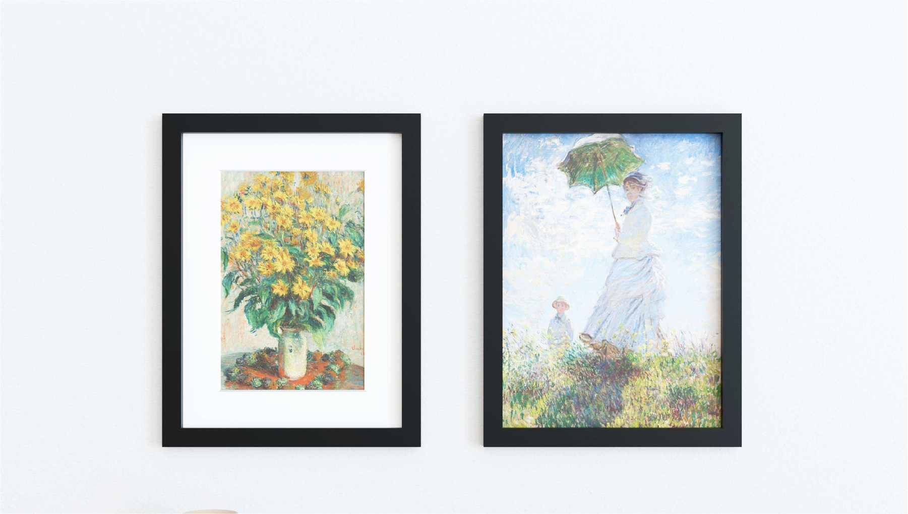 Two 18x24 frames featuring black solid wood borders and tempered glass covers hung up on a wall. 